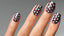 hand with short square nails with glossy brown nails and light blue polka dots