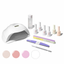 Nail care kit with lamp, nail polish bottles, and tools on a white background