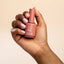 Hand holding a gel primer bottle with '14 Day Mani' text on a beige background